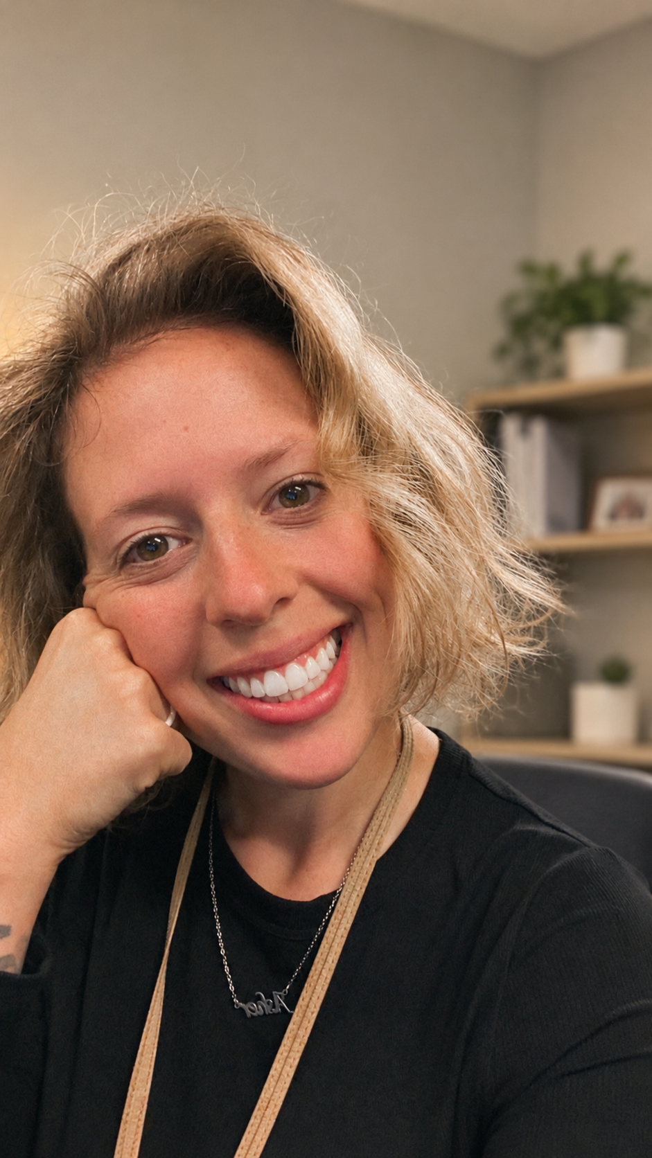 Haylee smiling in a warm office setting
